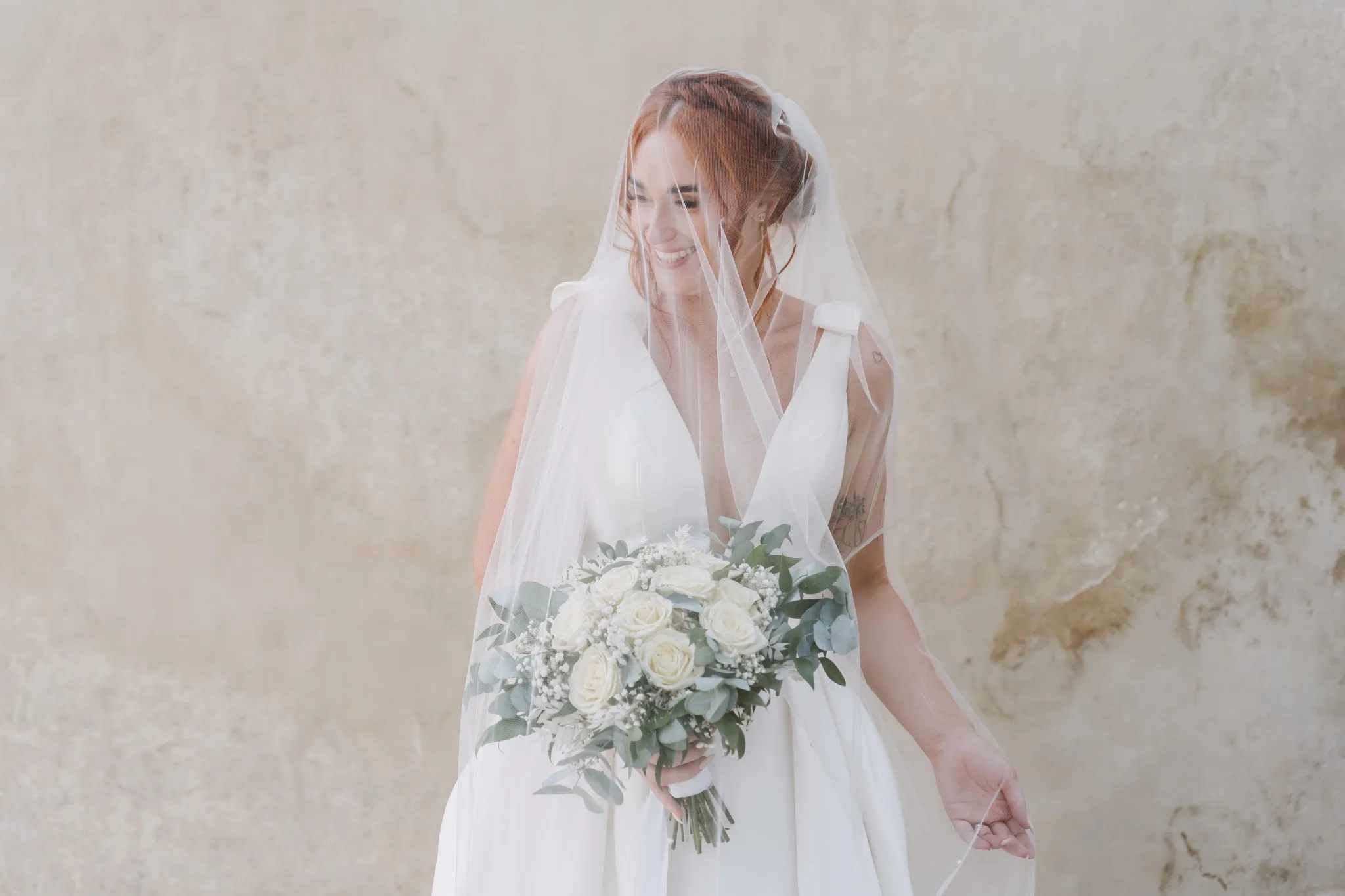 Bride photographed beneath her veil at Lake Bled