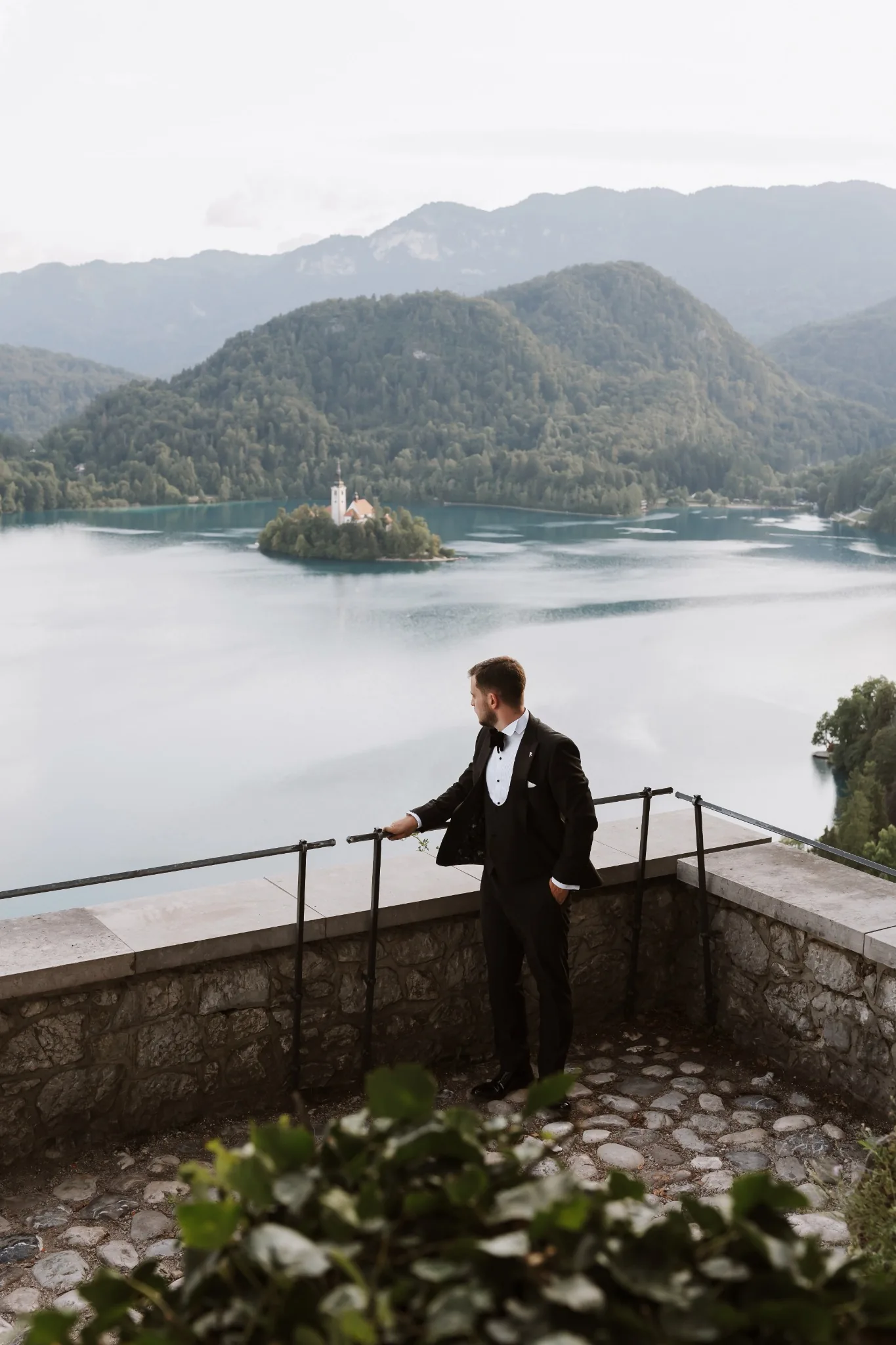 Groom overlooking Bled Island from Bled Castle