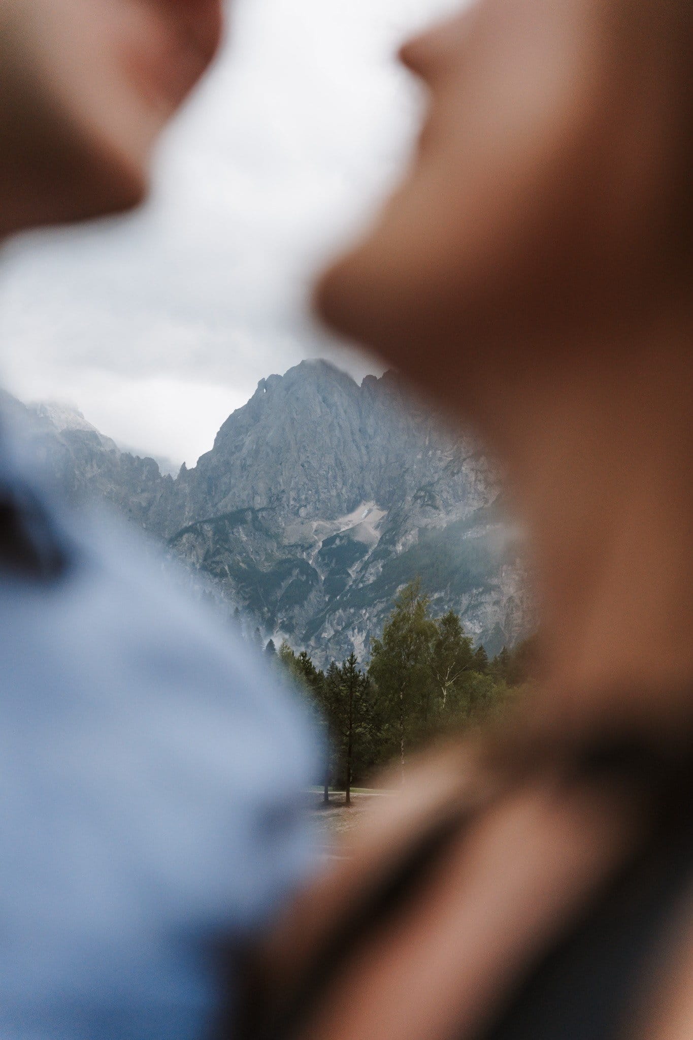 Rainy Lake Jasna proposal photographed through an intimate foreground with misty Julian Alps