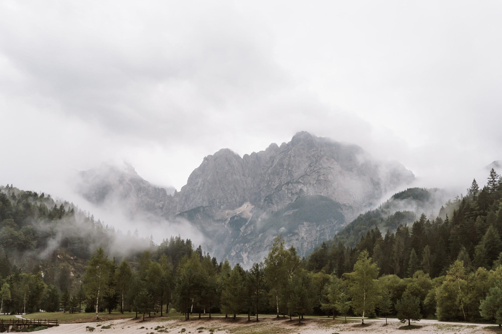 Misty Julian Alps above Lake Jasna on a rainy day in Kranjska Gora, Slovenia