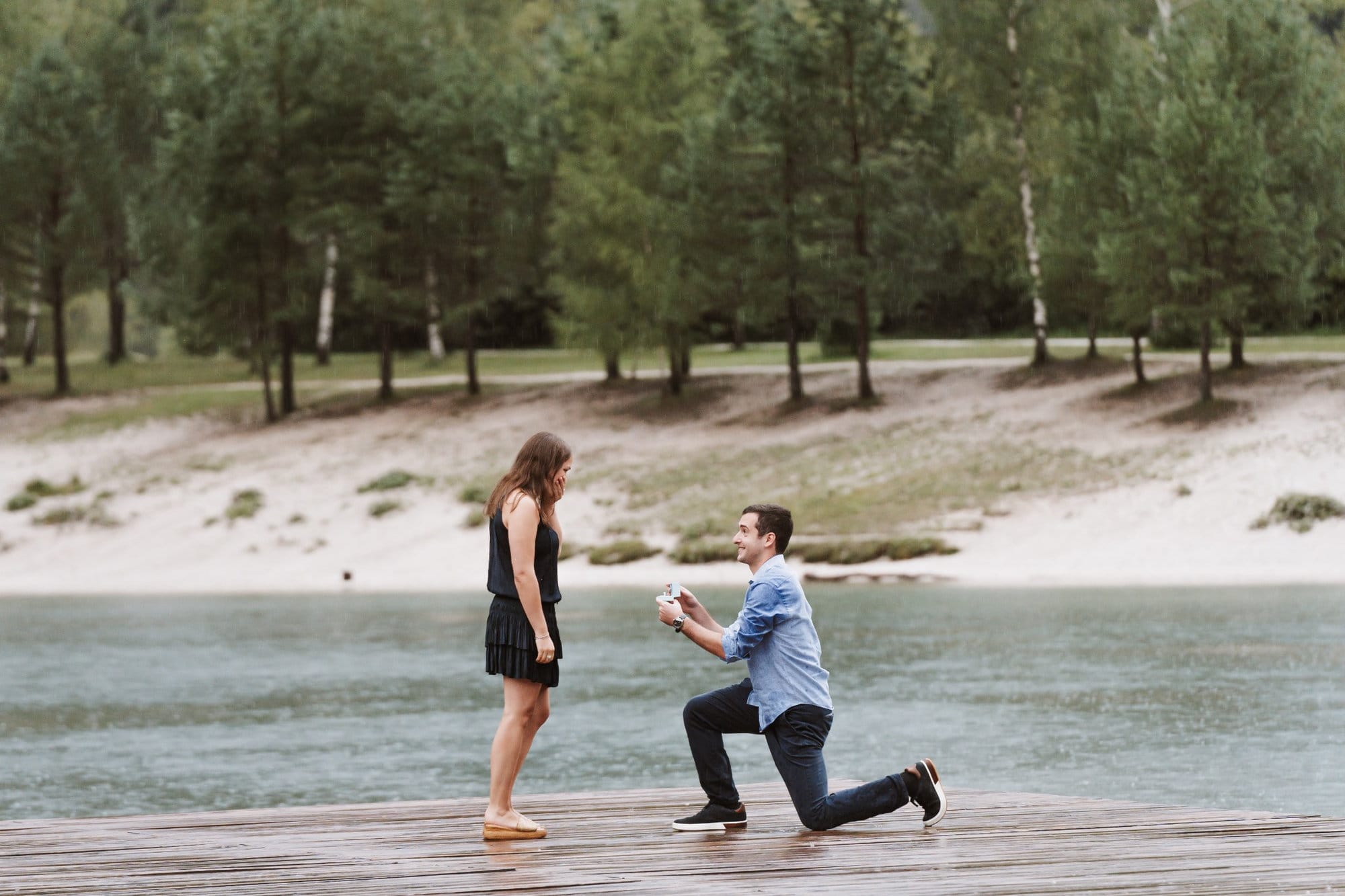 Surprise proposal on the wooden pier at Lake Jasna in Kranjska Gora, Slovenia